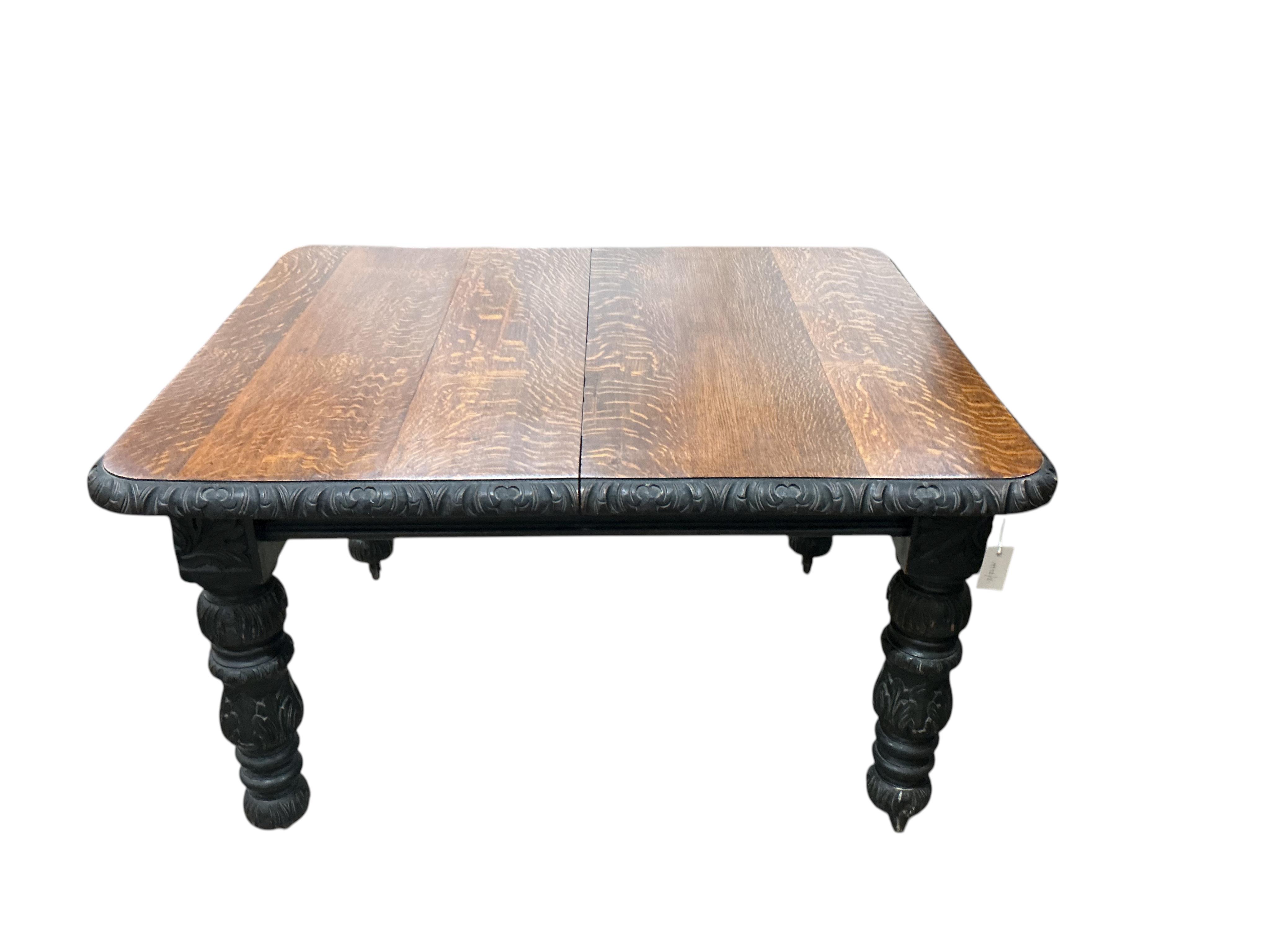 A late Victorian carved oak extending dining table, width 176cm extended, one spare leaf, depth 104cm, height 73cm